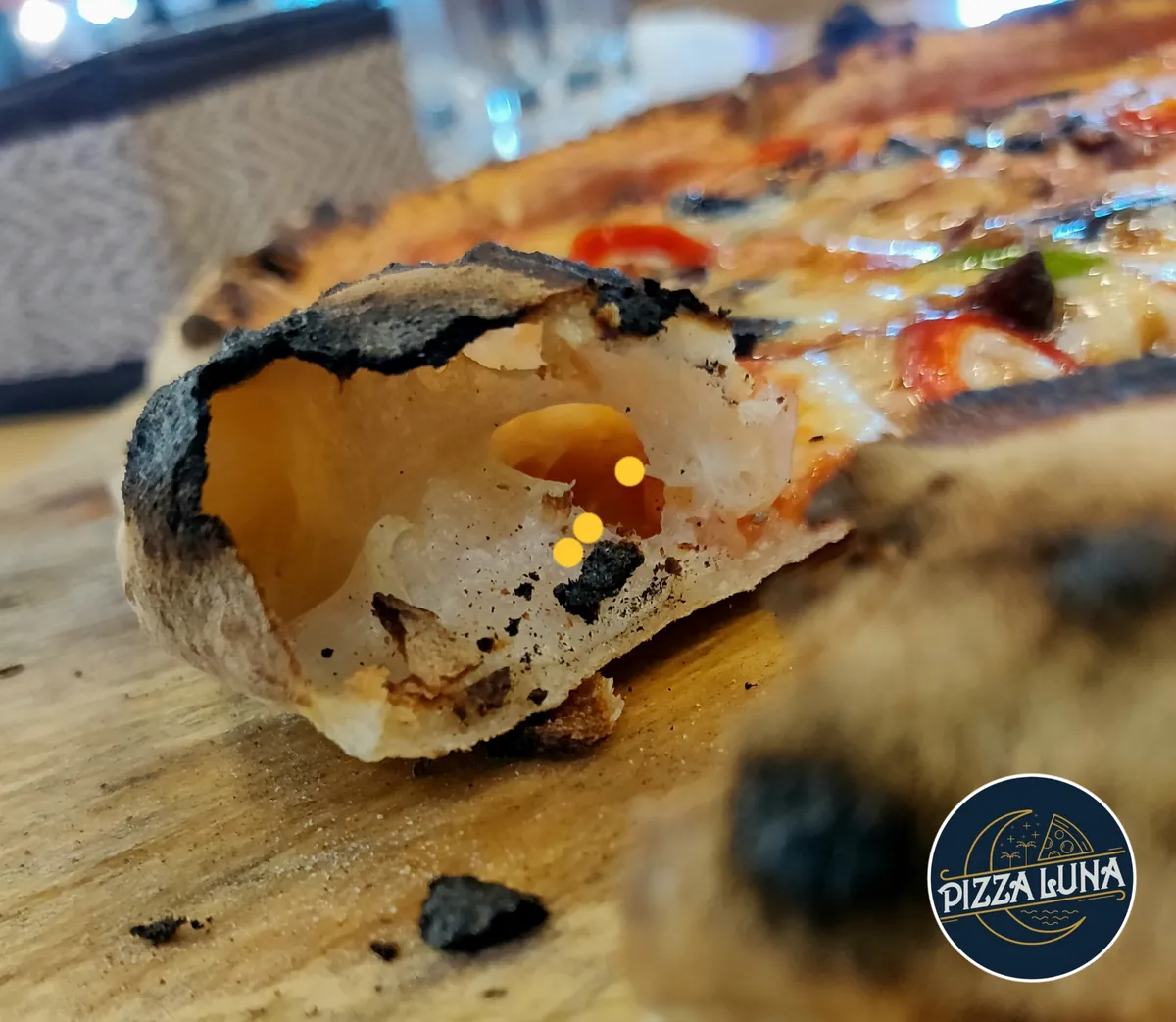 Close-up of an airy Pizza Luna sourdough crust pocket